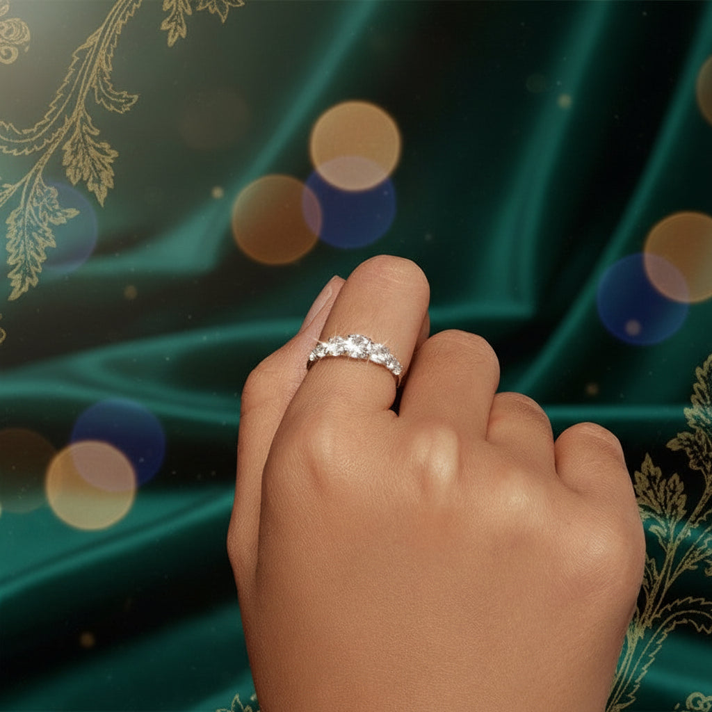 Hand wearing a diamond ring on a black background
